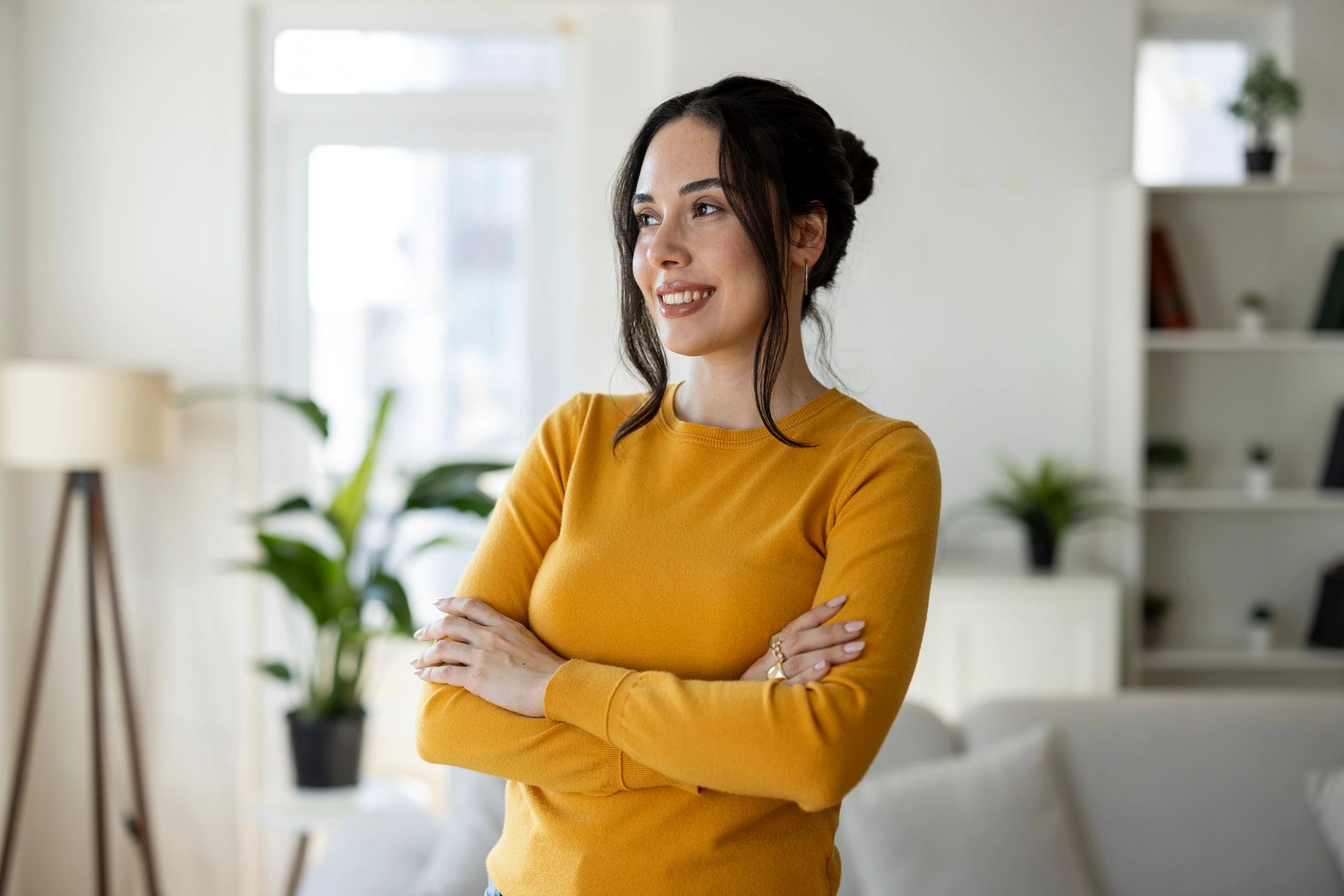 Optimistic woman standing confidently at home